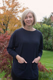 JUMPER WITH PEARL BUTTON BACK DETAIL, CURVED HEMLINE AND ROUNDED NECKLINE WITH 2 FRONT POCKETS